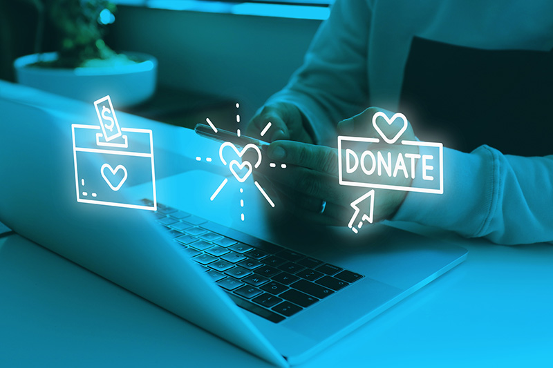 Image of person sitting at laptop with donation icons across the image.